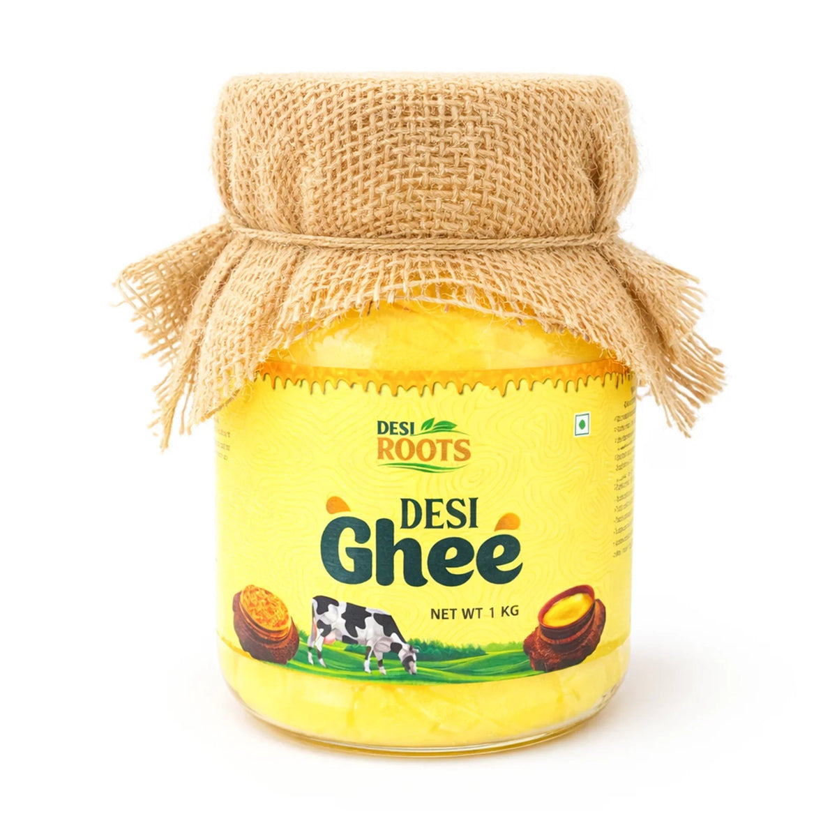 1kg jar of Desi Roots Pure Desi Ghee with traditional jute-wrapped lid and yellow label showing a grazing cow on a white background.