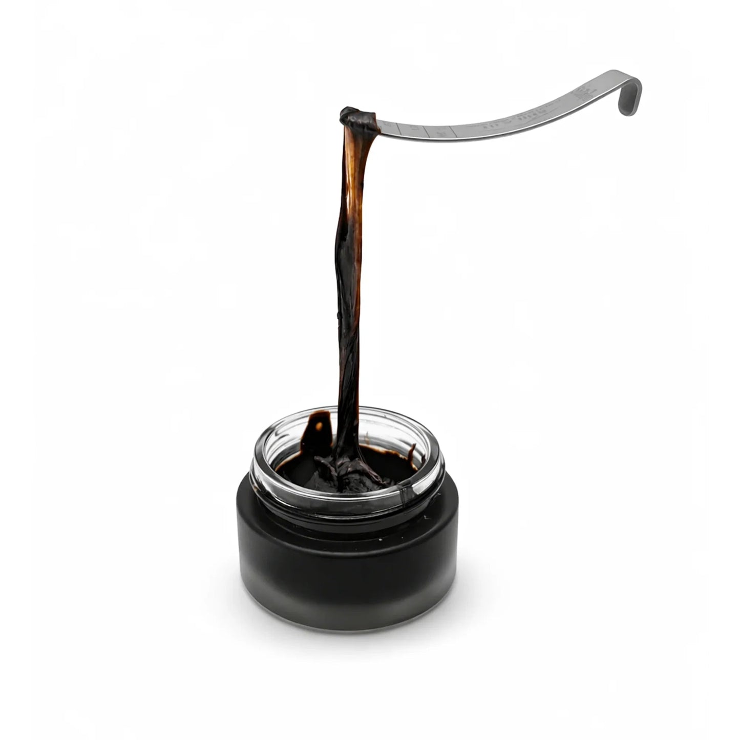 Shilajit with a dip pen on a white background