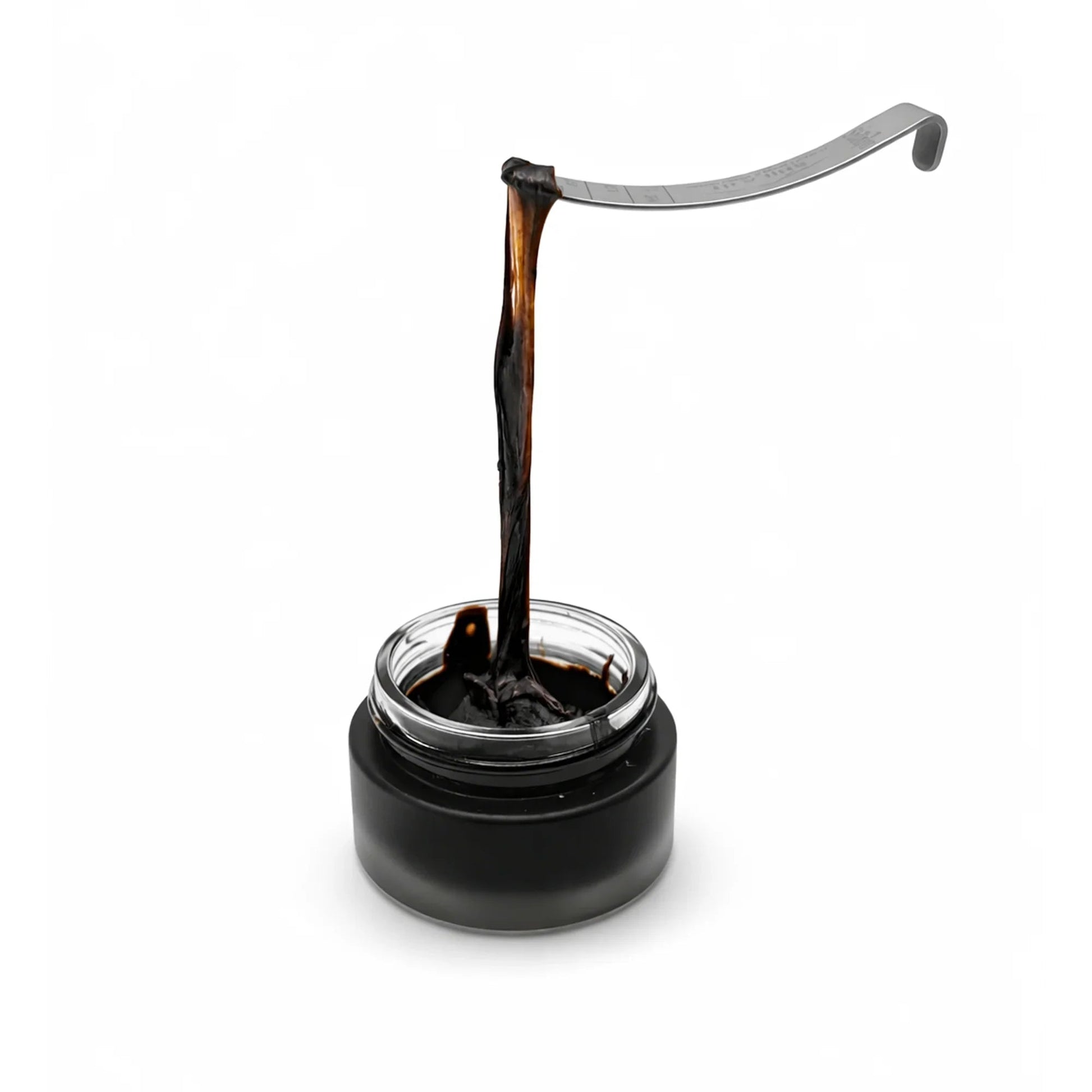 Shilajit with a dip pen on a white background